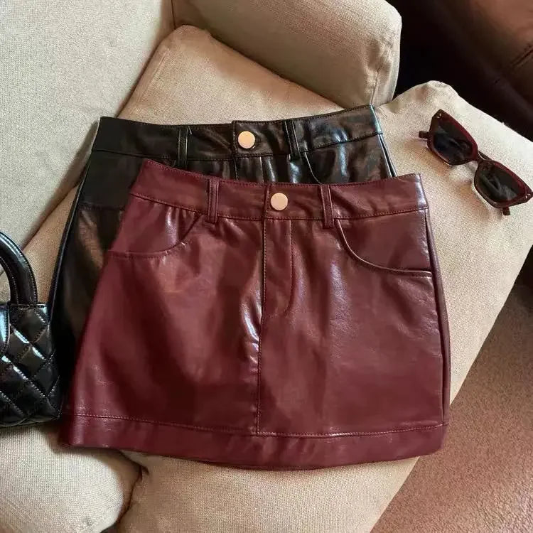 Wine red PU leather skirt half skirt for women, 2024 autumn and winter anti glare A-line hip hugging short skirt